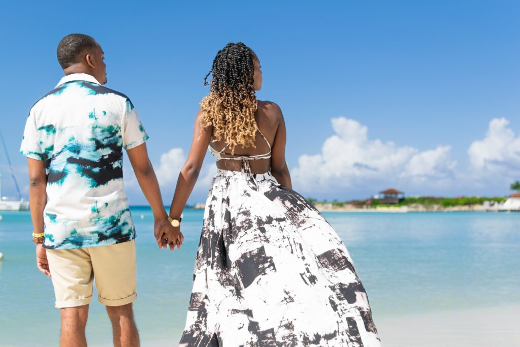 young,black,couple,holding,hands,on,the,beach,,photographed,from young,black,couple,holding,hands,on,the,beach,,photographed,from